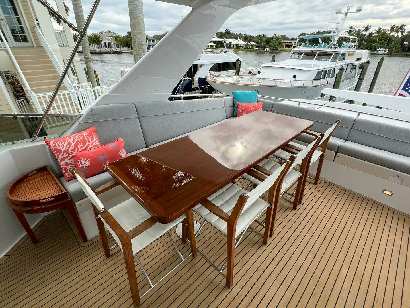 a table and chairs on a balcony aboard AT EASE Yacht for Sale