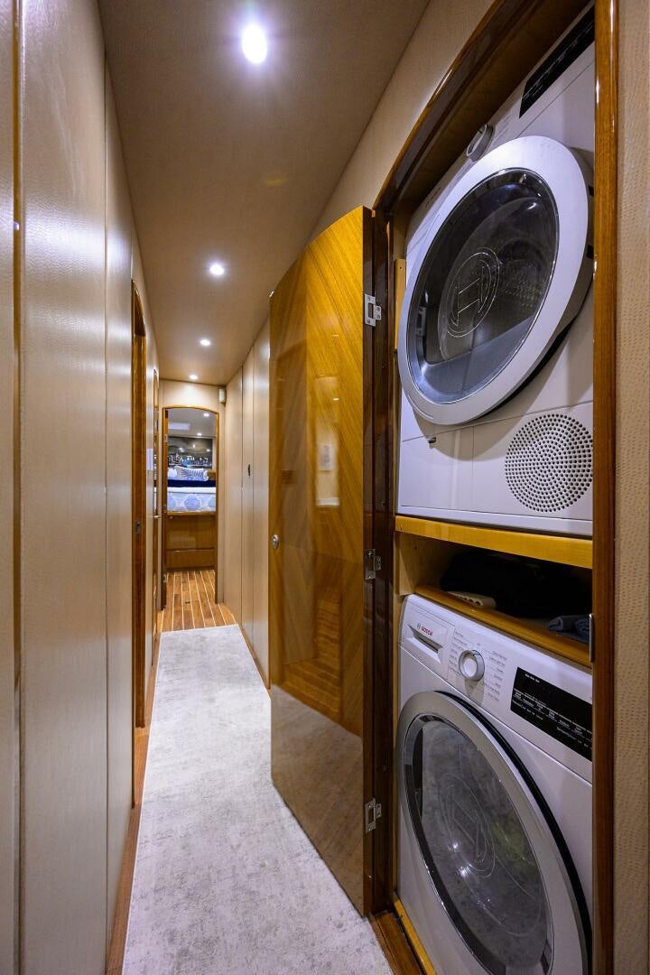 a hallway with washing machines aboard CODE BLU Yacht for Sale