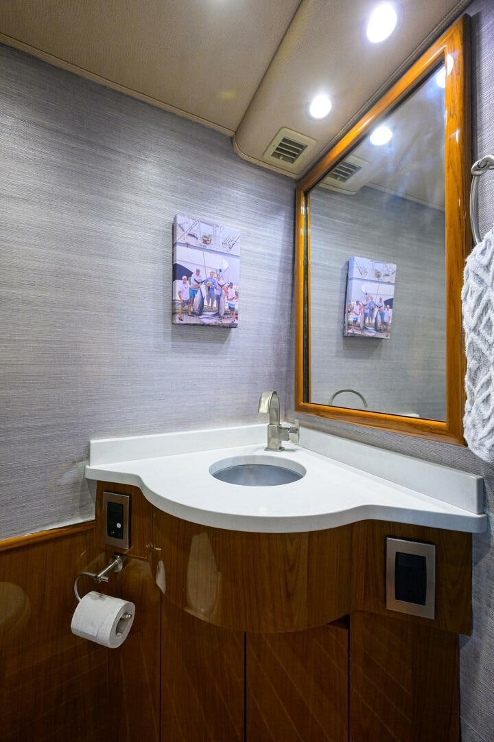 a bathroom with a mirror and a sink aboard CODE BLU Yacht for Sale