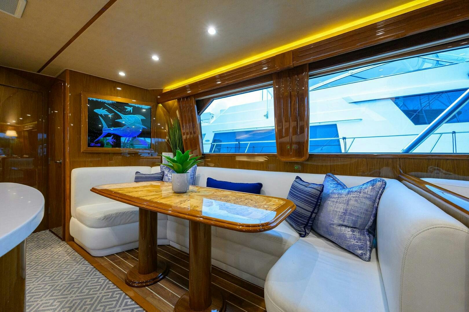a room with a couch and a table and a window aboard CODE BLU Yacht for Sale