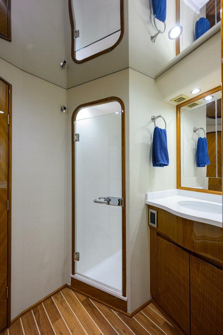 a bathroom with a shower and sink aboard CODE BLU Yacht for Sale