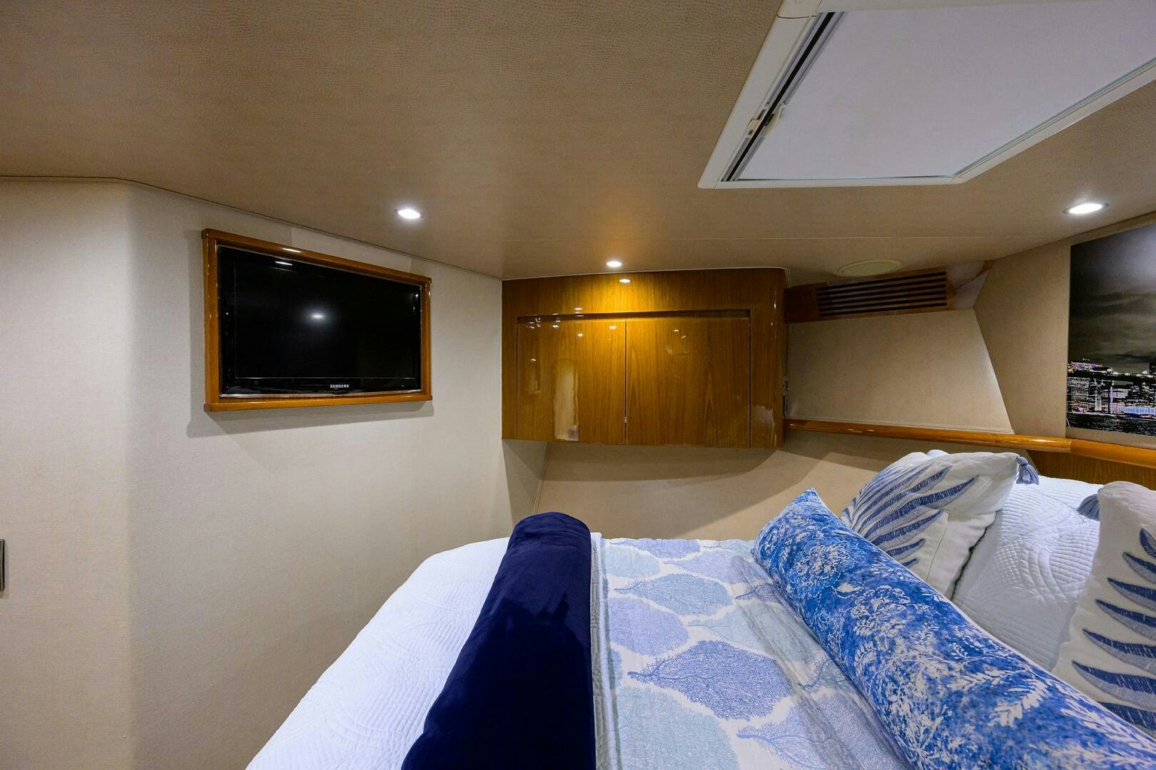 a bedroom with a tv on the wall aboard CODE BLU Yacht for Sale