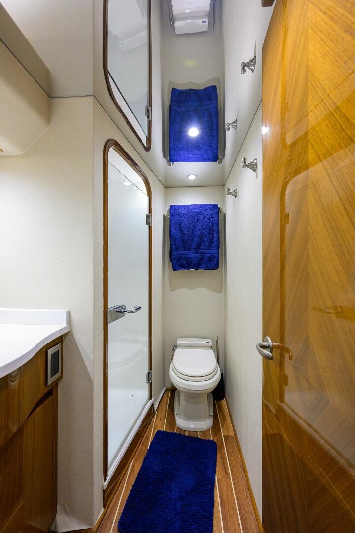 a bathroom with a toilet and a mirror aboard CODE BLU Yacht for Sale