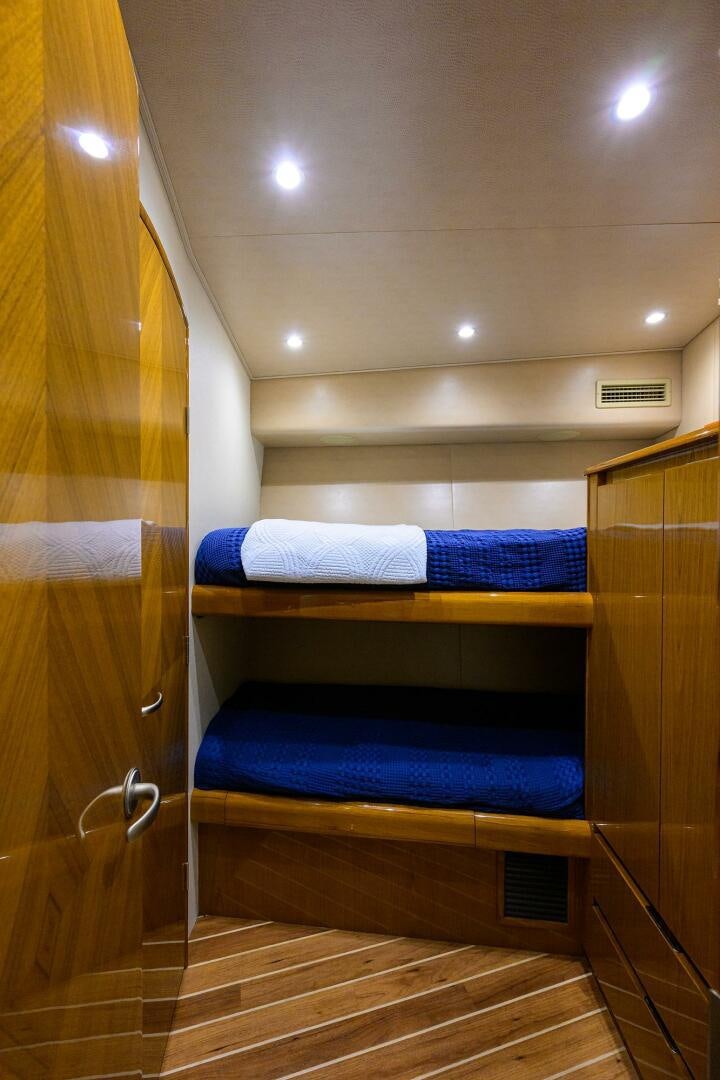 a wooden closet with a bed aboard CODE BLU Yacht for Sale