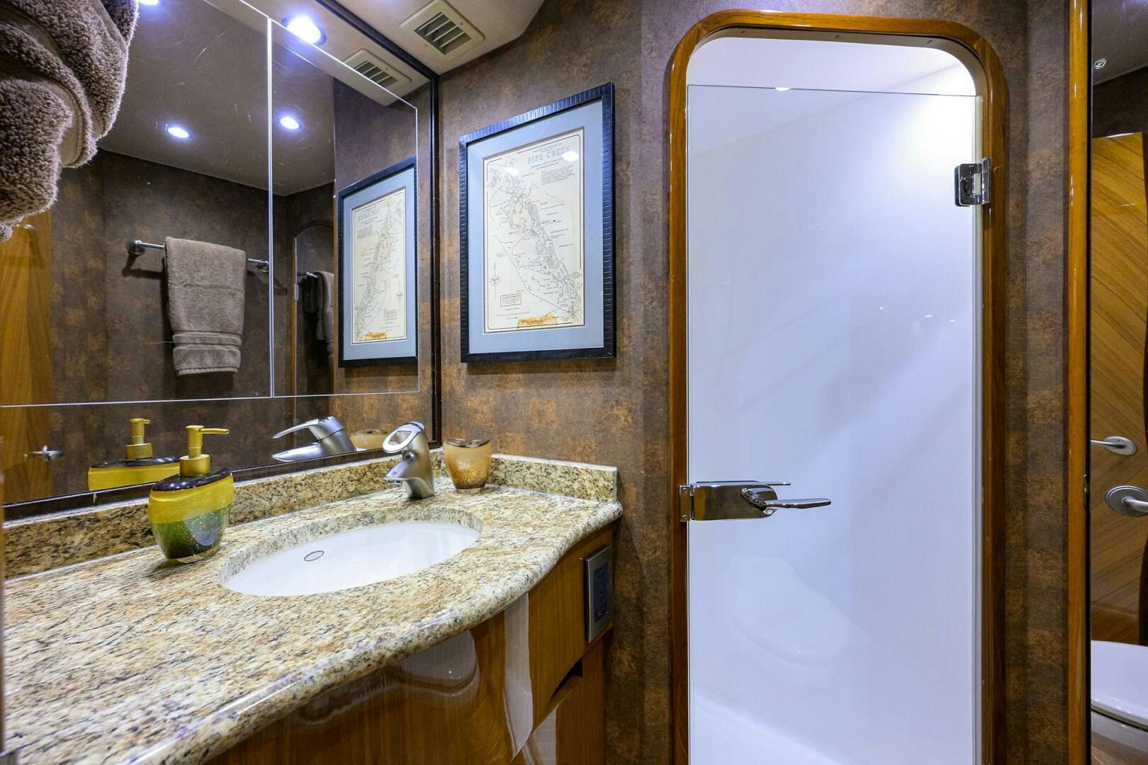 a bathroom with a sink and mirror aboard CABALLO GRANDE Yacht for Sale