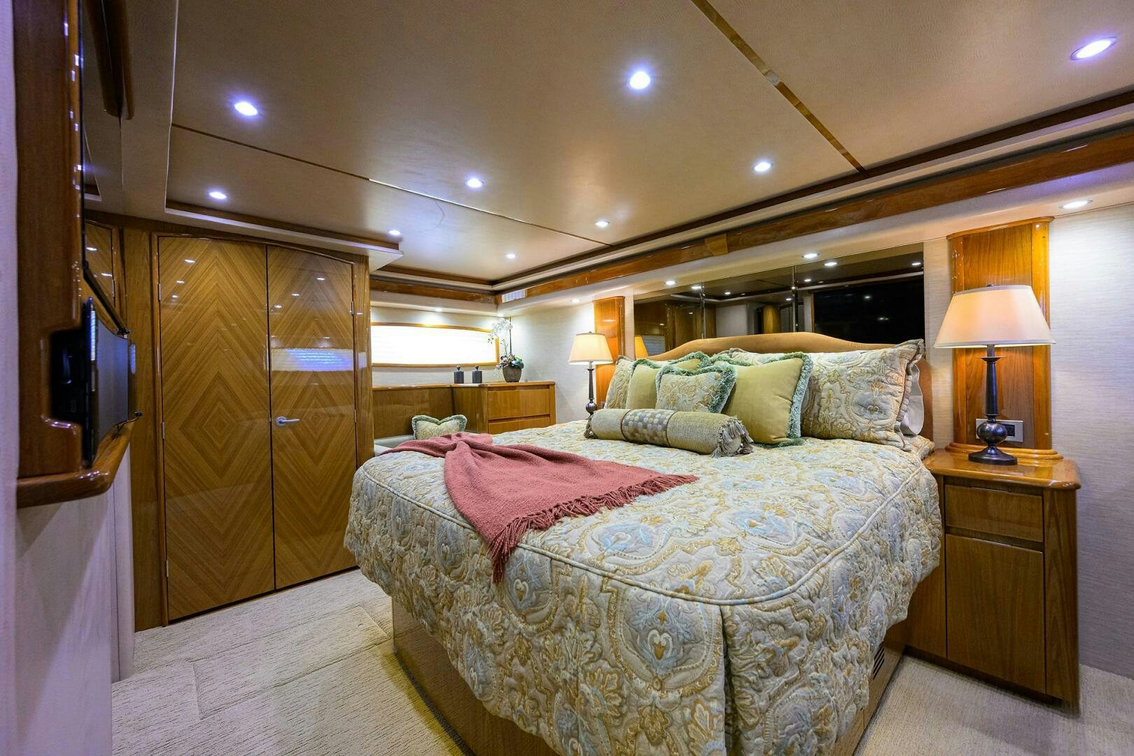 a bedroom with a bed and a lamp aboard CABALLO GRANDE Yacht for Sale