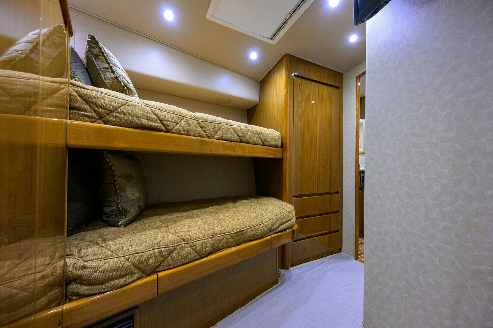 a bed with a brown comforter aboard CABALLO GRANDE Yacht for Sale