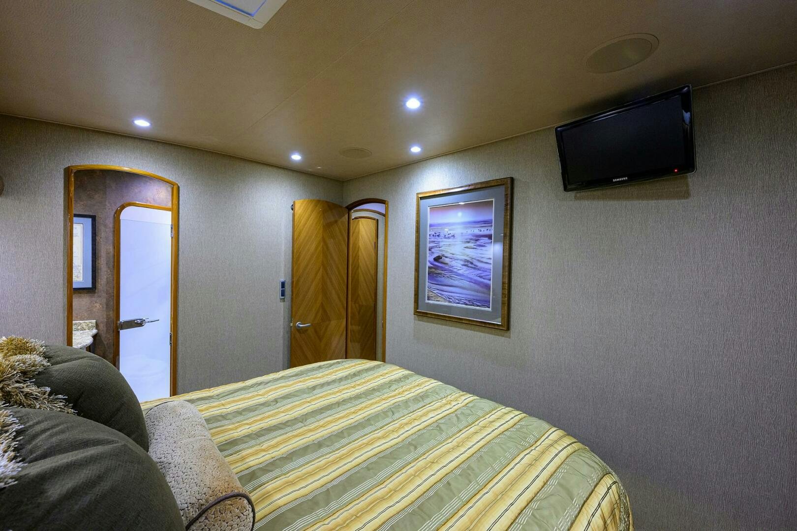 a bedroom with a tv and a bed aboard CABALLO GRANDE Yacht for Sale