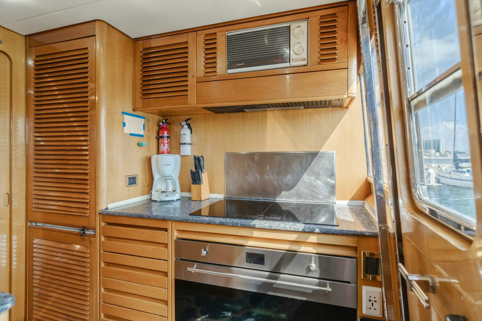 a kitchen with wooden cabinets aboard C LADY Yacht for Sale