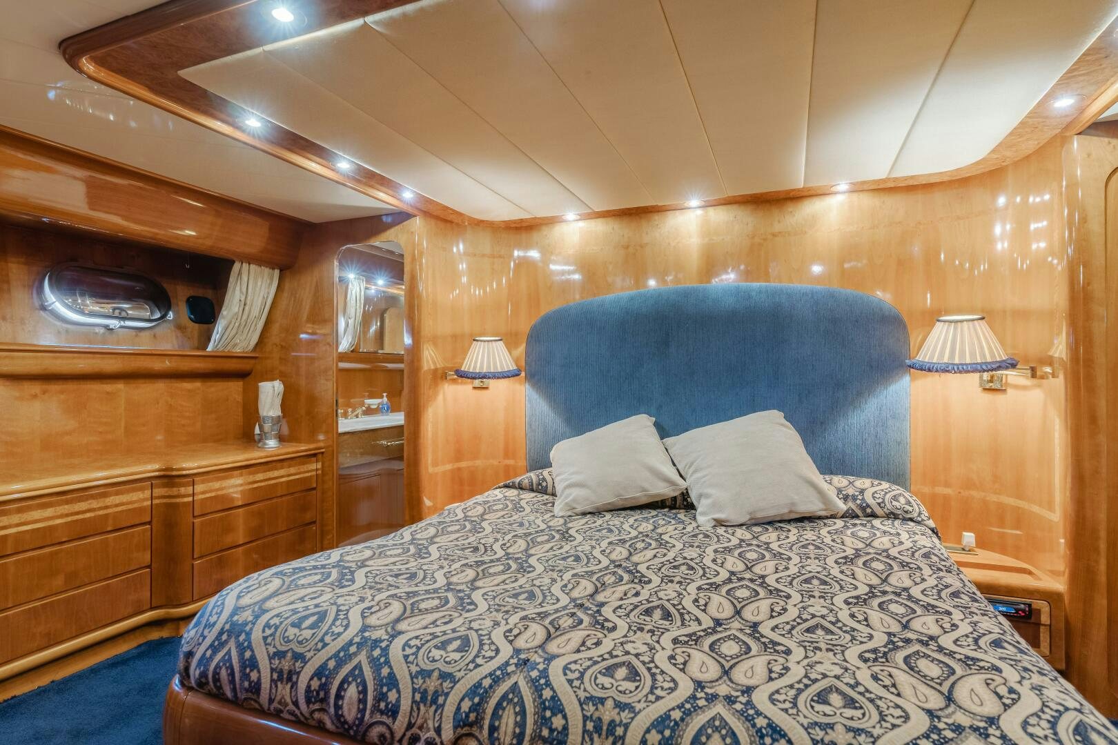 a bed with a blue blanket aboard C LADY Yacht for Sale