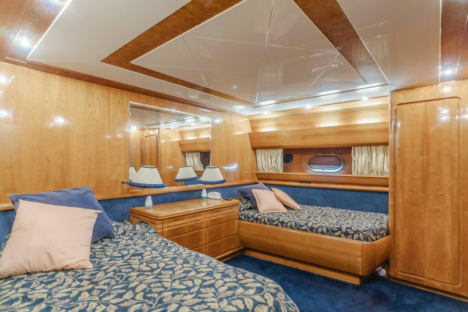 a room with a bed and a wood cabinet aboard C LADY Yacht for Sale