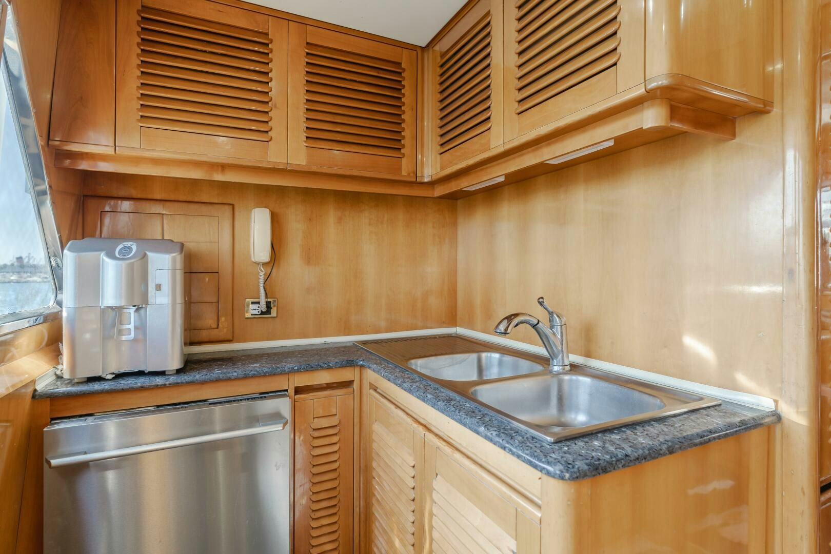 a kitchen with wooden cabinets aboard C LADY Yacht for Sale