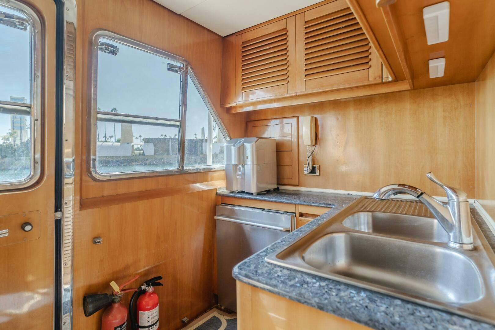 a kitchen with wooden cabinets aboard C LADY Yacht for Sale