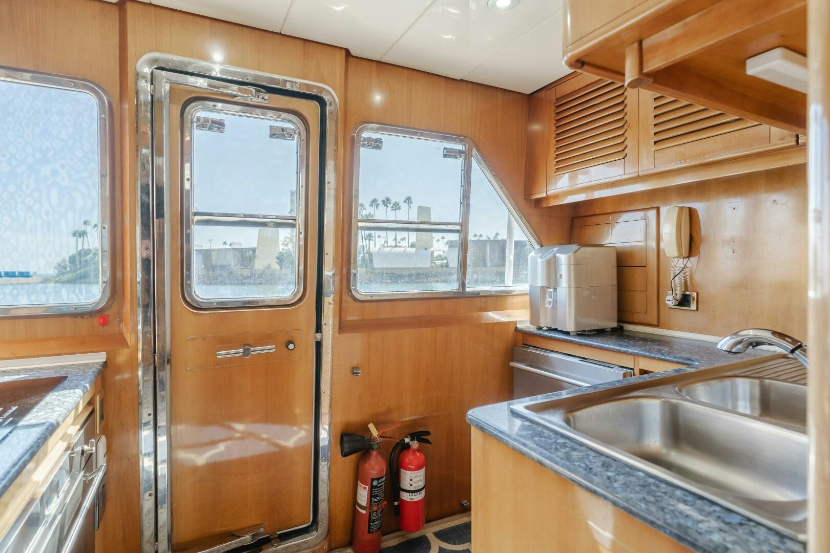 a kitchen with wooden cabinets aboard C LADY Yacht for Sale