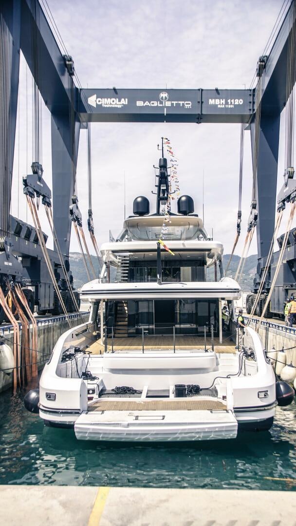 a large white boat in a harbor aboard BAGLIETTO T52 HULL 4 Yacht for Sale