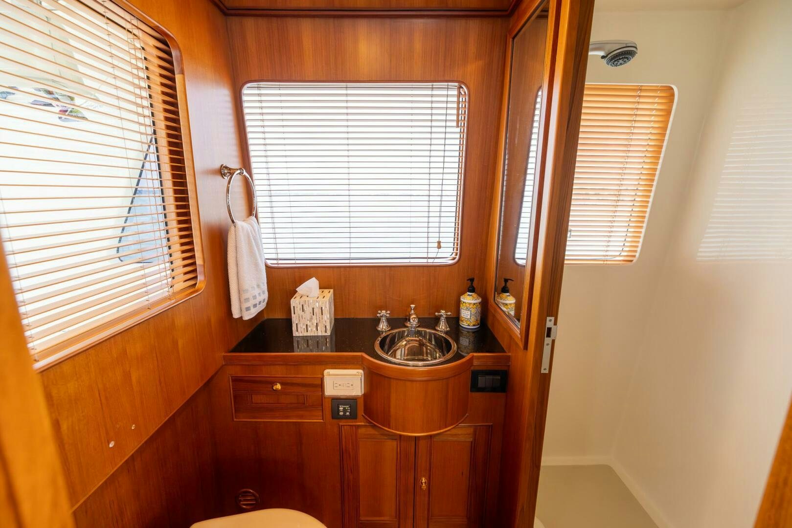 a bathroom with a sink and a window aboard INDIGO Yacht for Sale