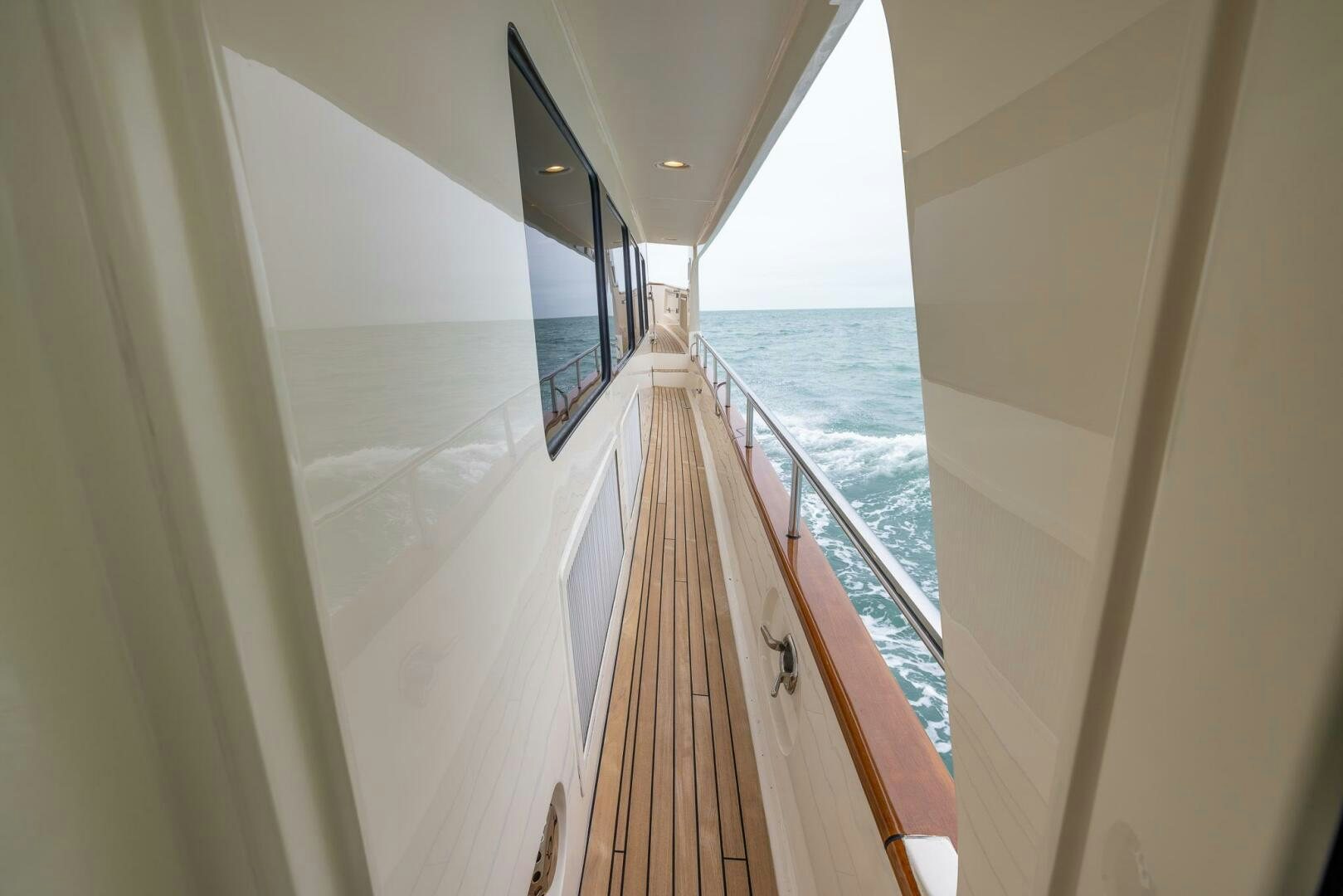 a long hallway with a railing aboard INDIGO Yacht for Sale