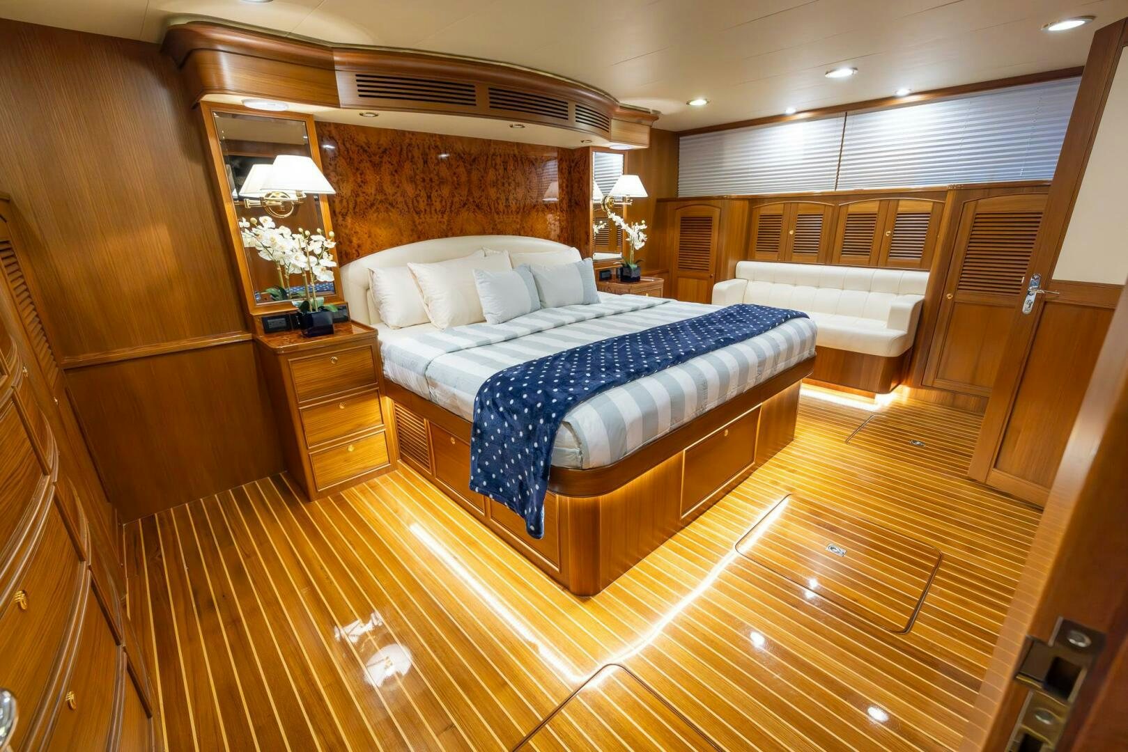 a room with a bed and a wood wall aboard INDIGO Yacht for Sale