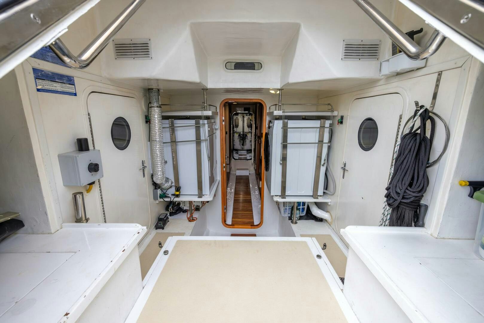 a hallway with a door and a mirror aboard INDIGO Yacht for Sale