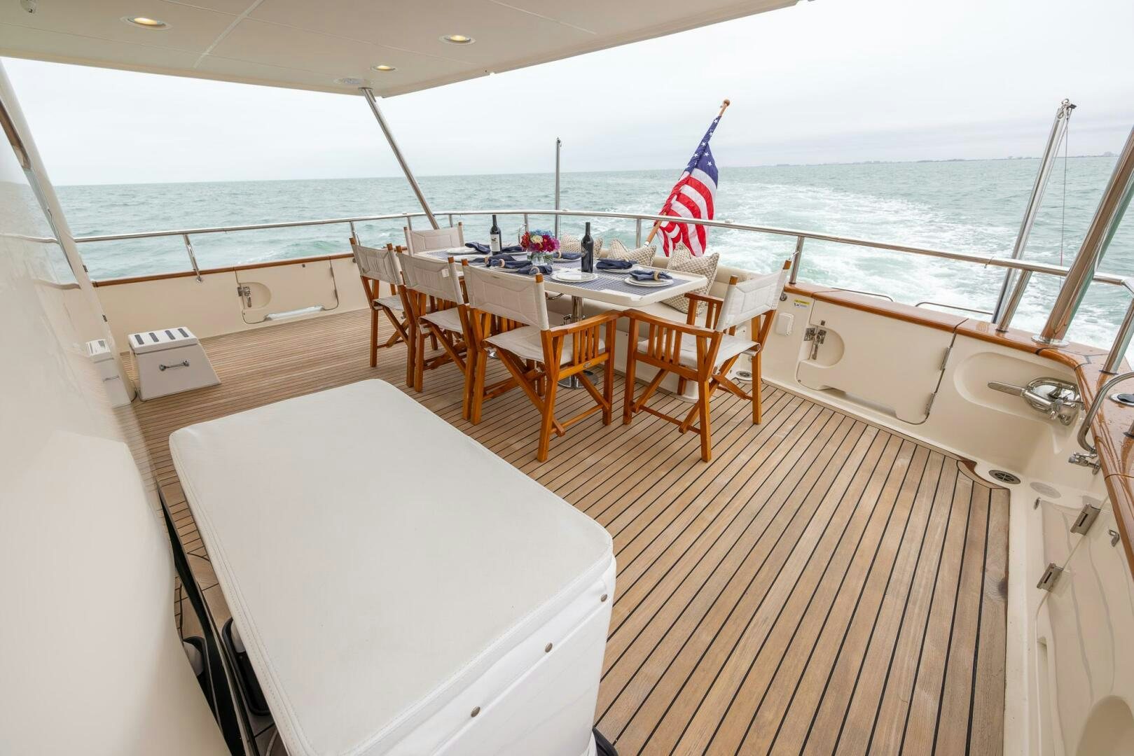 a boat with a table and chairs on the deck aboard INDIGO Yacht for Sale