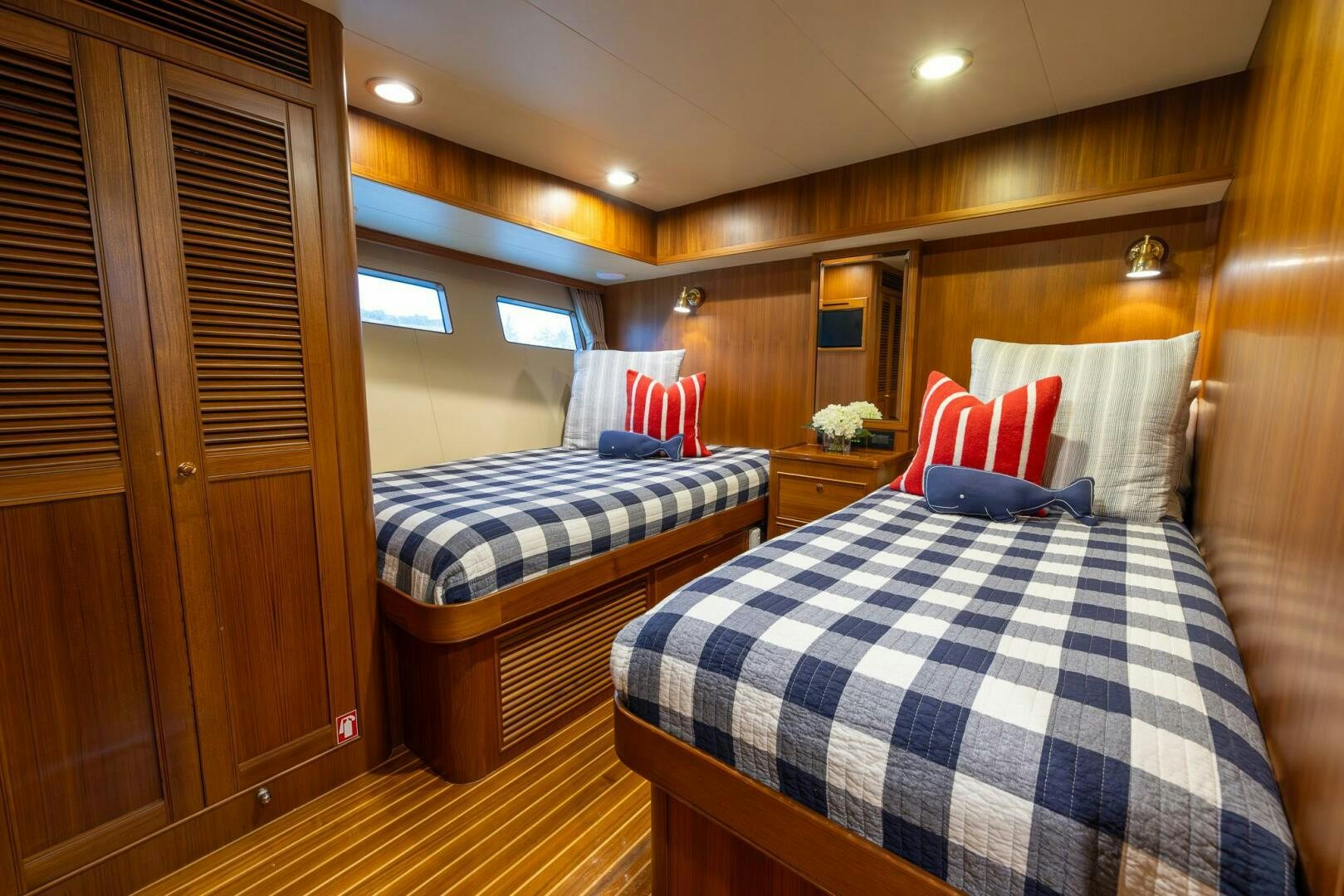 a bedroom with a bed and a closet aboard INDIGO Yacht for Sale
