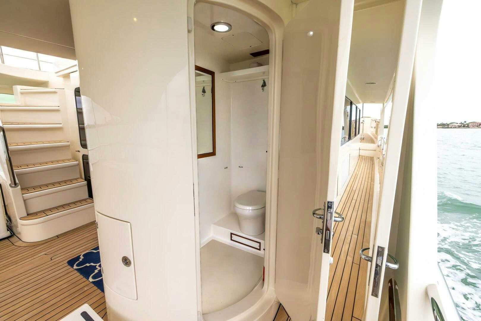 a bathroom with a toilet and a mirror aboard INDIGO Yacht for Sale