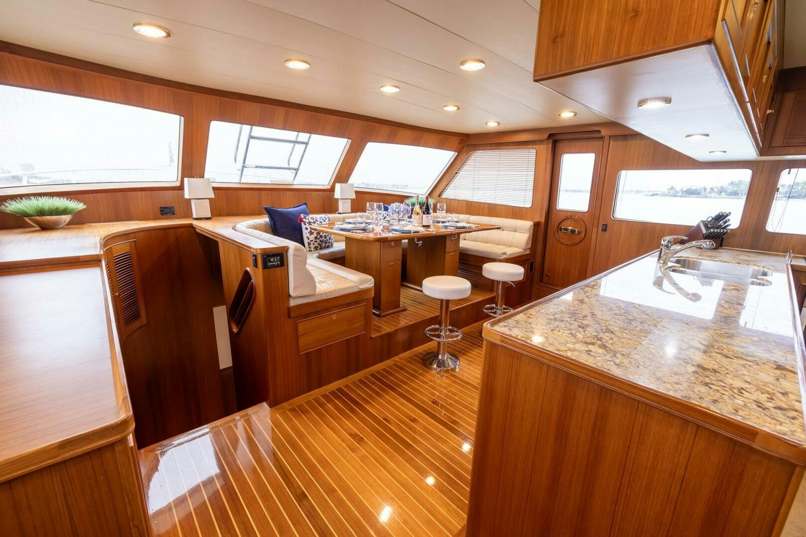 a kitchen with a bar and a table aboard INDIGO Yacht for Sale