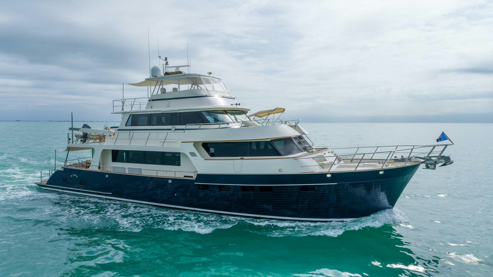 a large white boat in the water aboard INDIGO Yacht for Sale