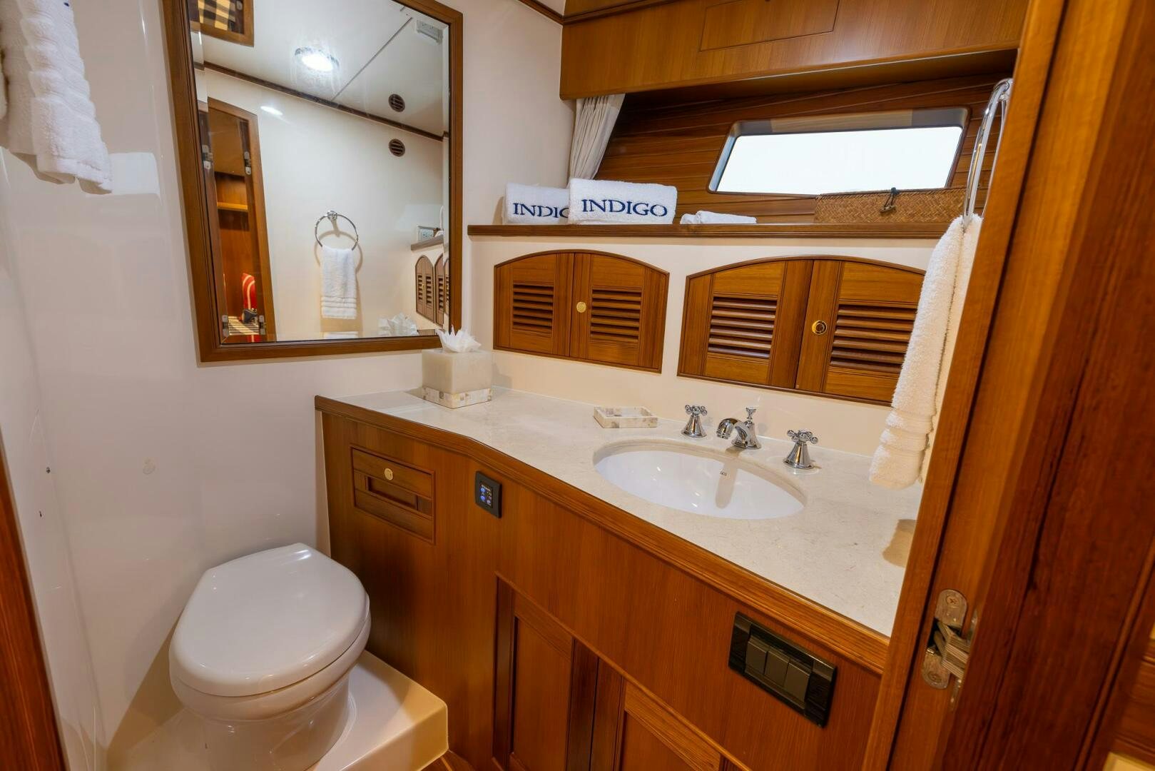 a bathroom with a toilet and a sink aboard INDIGO Yacht for Sale