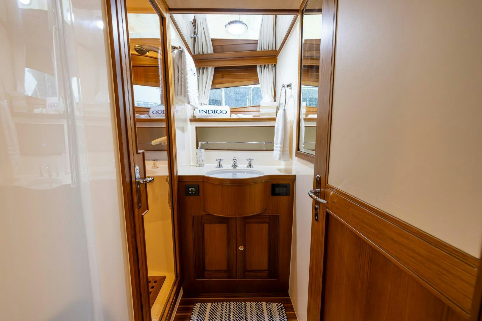 a bathroom with a sink and a mirror aboard INDIGO Yacht for Sale