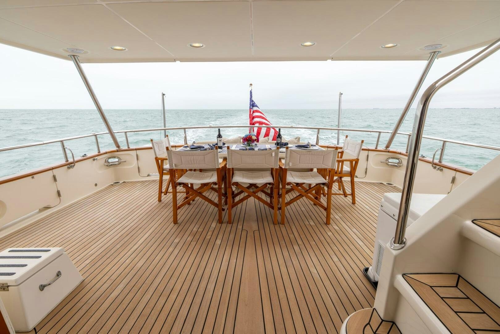 a boat with tables and chairs on a deck aboard INDIGO Yacht for Sale