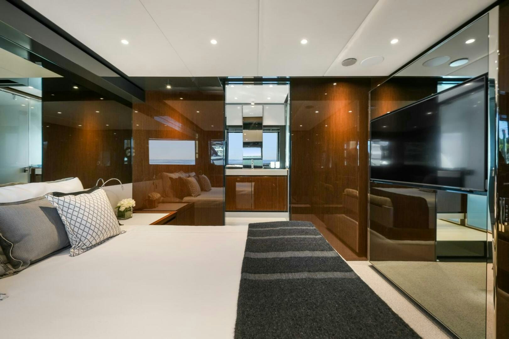 a room with a bed and a tv aboard BLUEPRINT Yacht for Sale