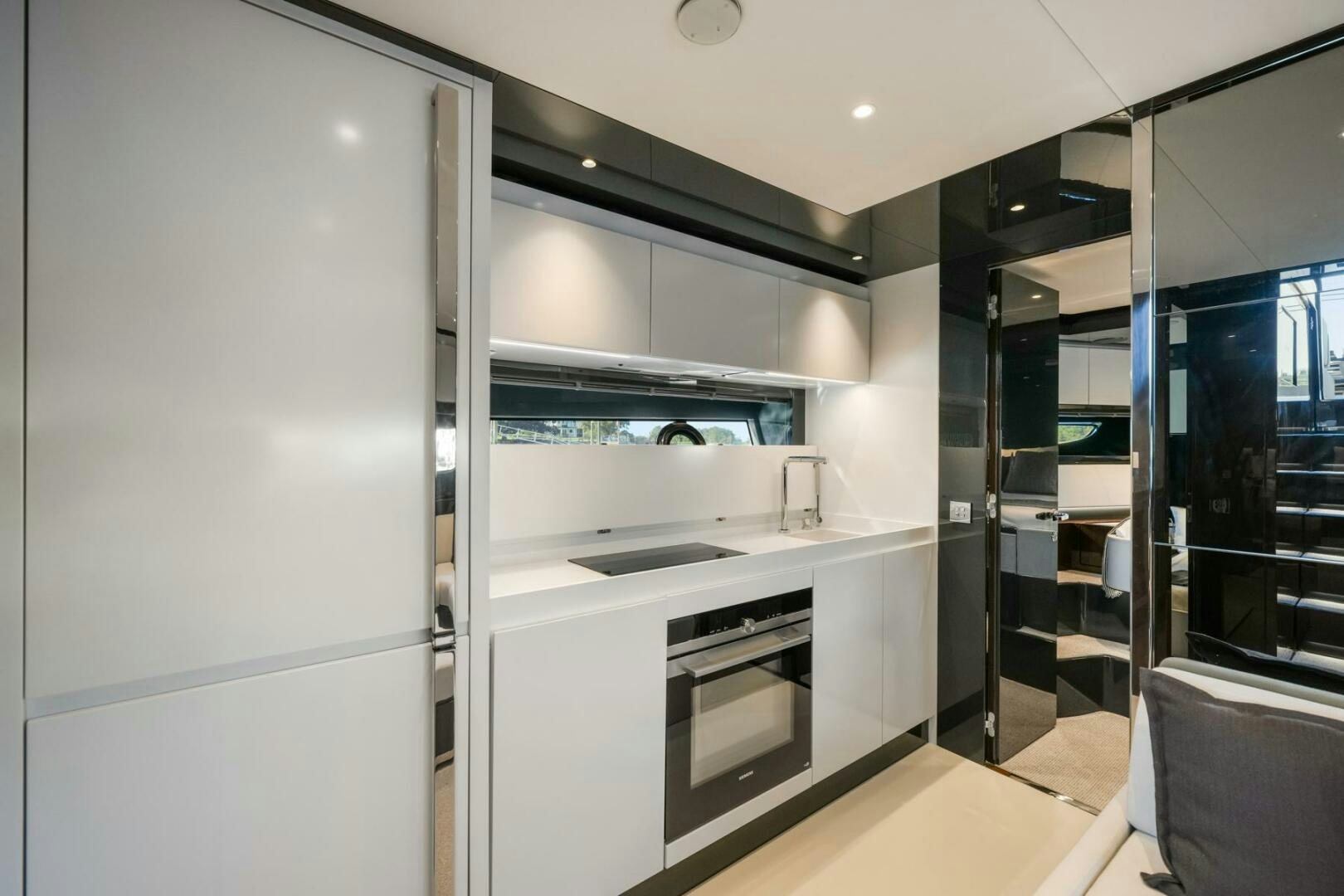 a kitchen with a refrigerator and a sink aboard BLUEPRINT Yacht for Sale