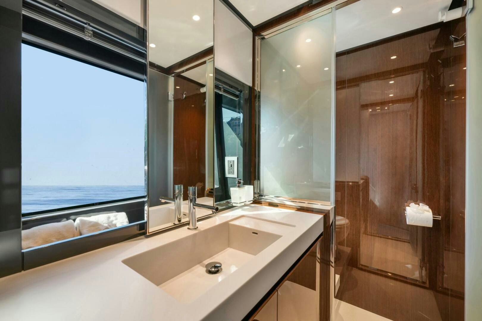 a bathroom with a large window aboard BLUEPRINT Yacht for Sale