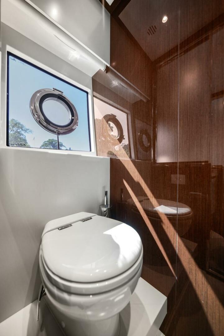 a toilet with a mirror above it aboard BLUEPRINT Yacht for Sale