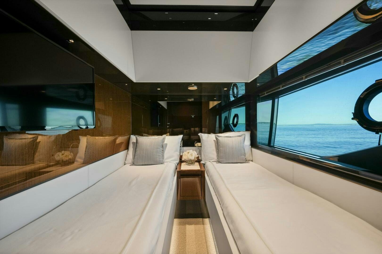 a room with a bed and a window aboard BLUEPRINT Yacht for Sale