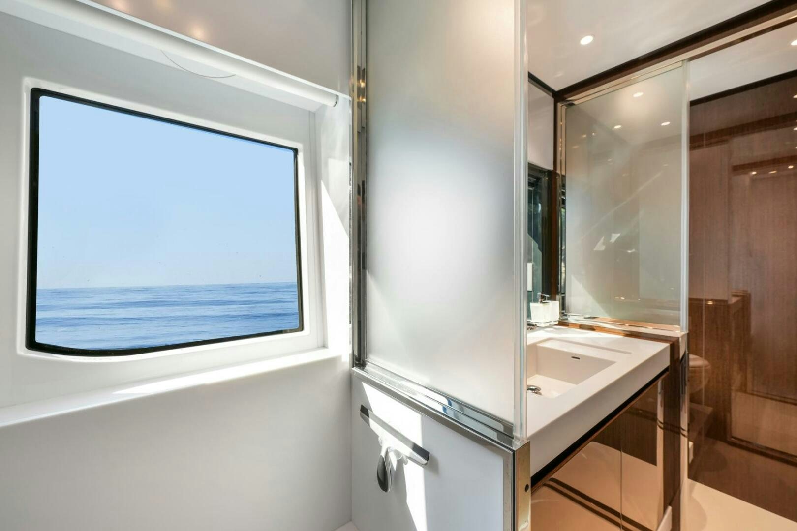 a bathroom with a large window aboard BLUEPRINT Yacht for Sale
