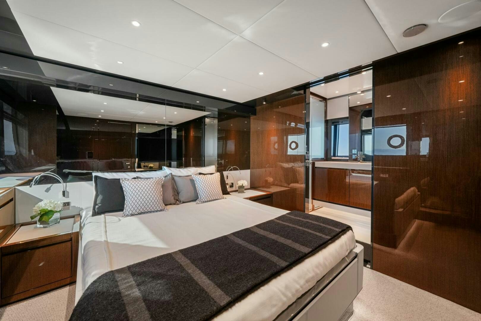 a modern bedroom with a large bed aboard BLUEPRINT Yacht for Sale