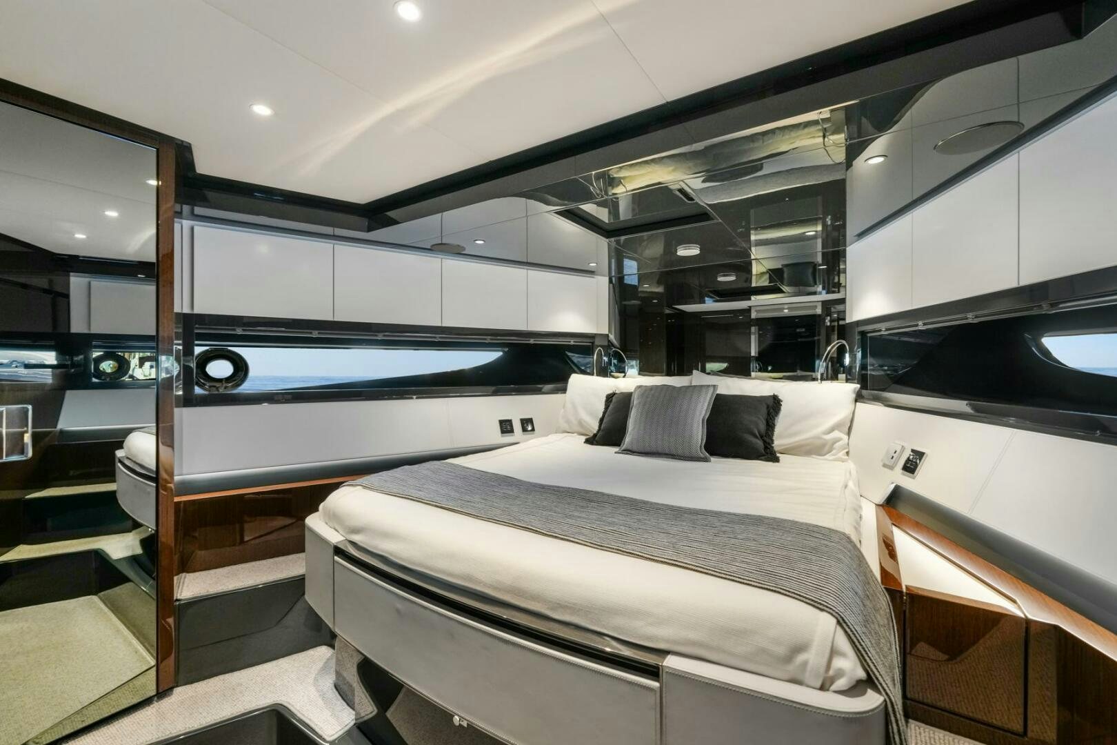 a room with a bed and a mirror aboard BLUEPRINT Yacht for Sale