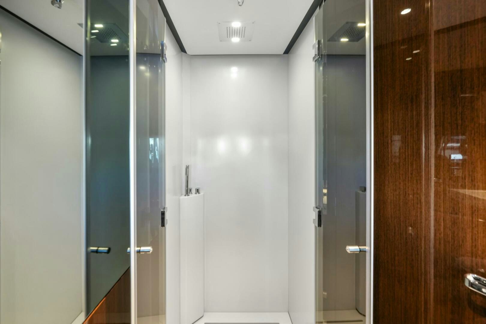 a room with doors and a mirror aboard BLUEPRINT Yacht for Sale