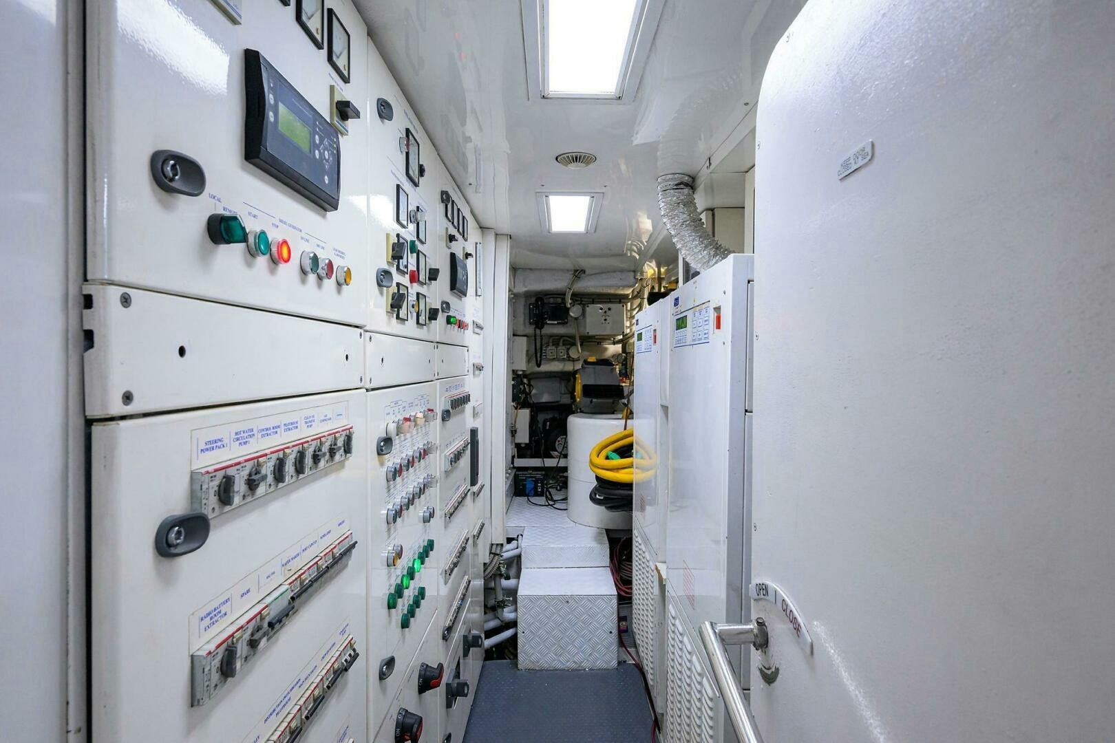 a room with white walls and a white wall with pictures on it aboard ARTHUR’S WAY Yacht for Sale