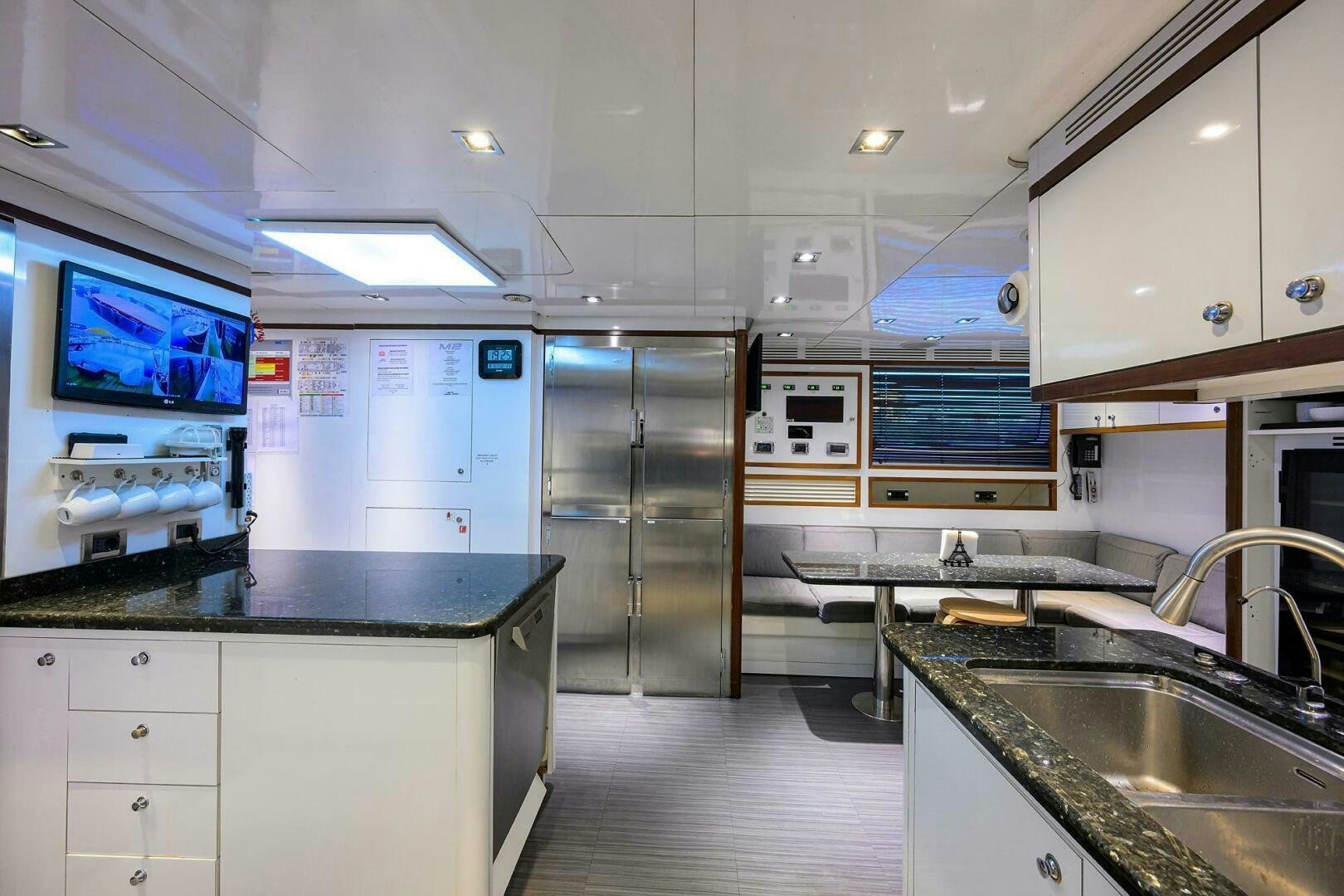 a kitchen with a fridge and a sink aboard ARTHUR’S WAY Yacht for Sale