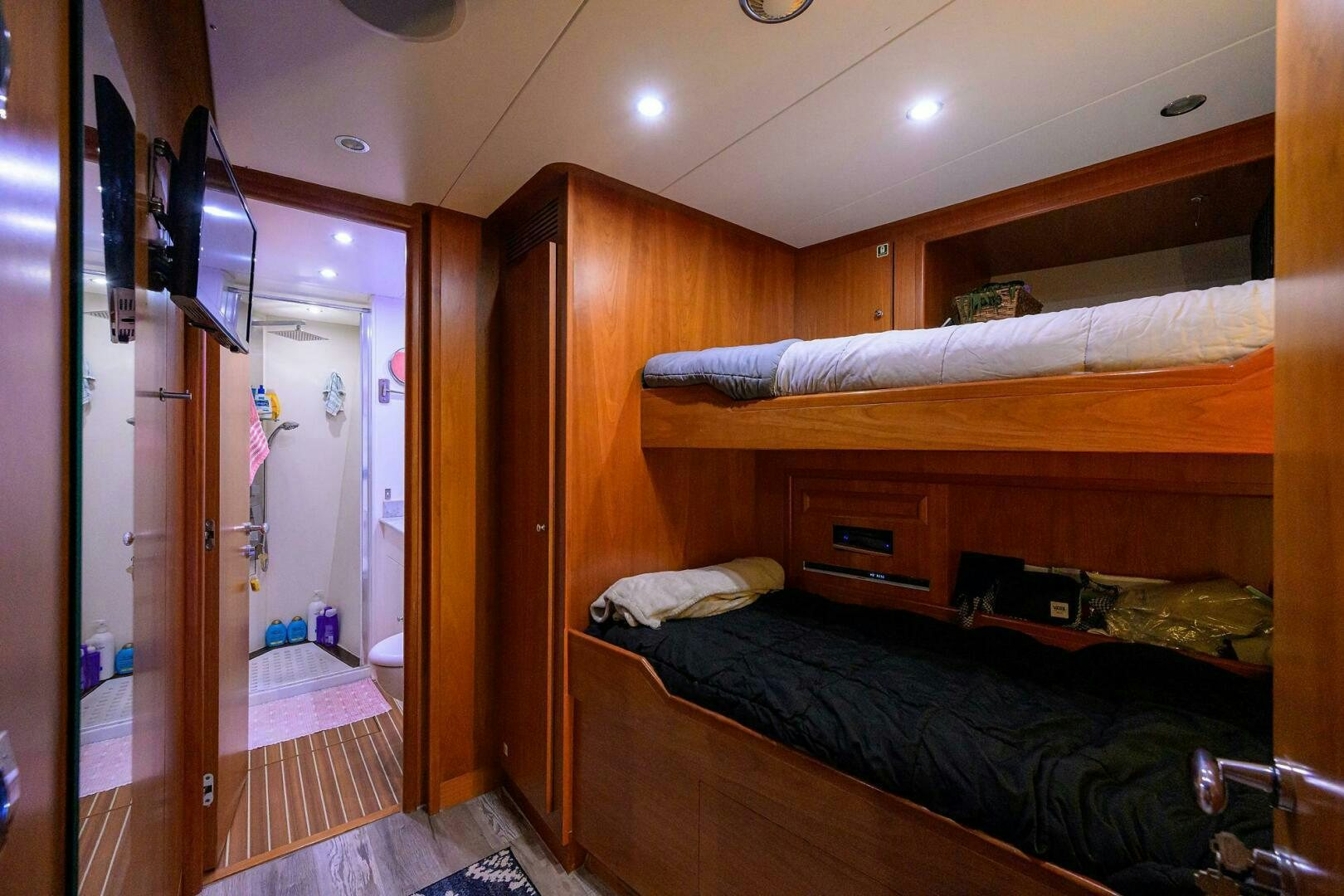 a bedroom with a bed and a closet aboard ARTHUR’S WAY Yacht for Sale