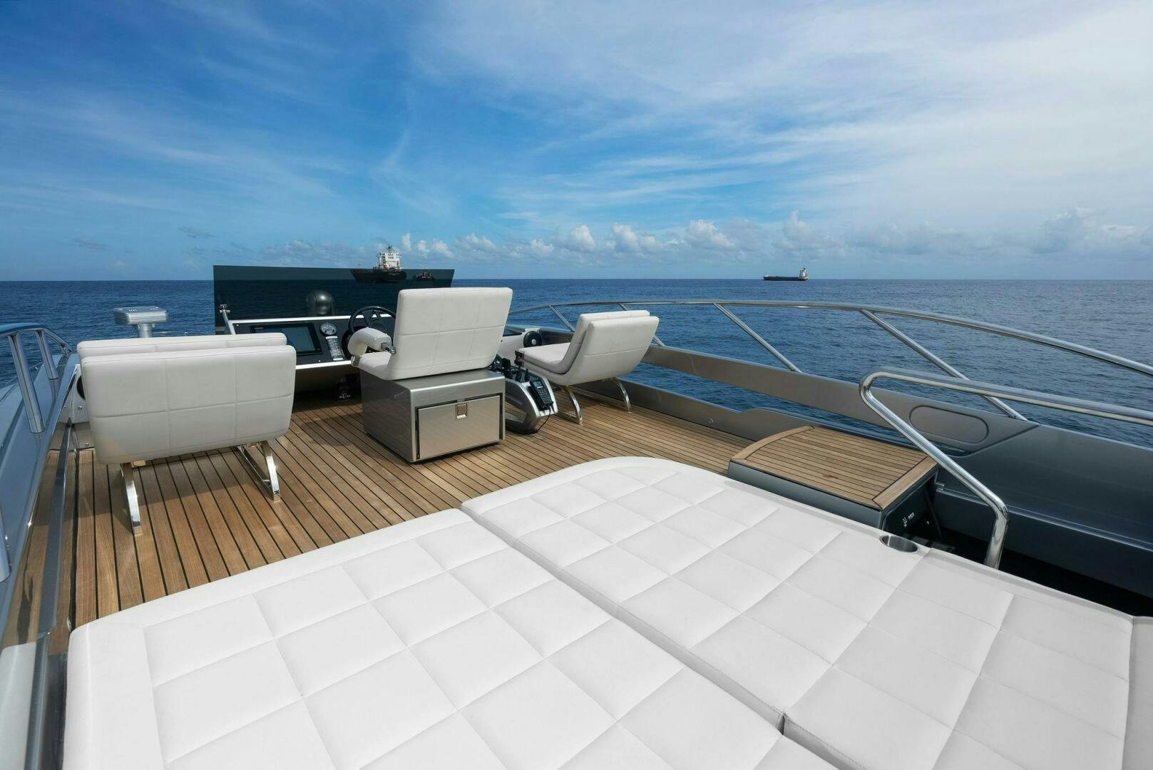 a deck with chairs on it and a body of water in the background aboard PHOENIX RISING Yacht for Sale