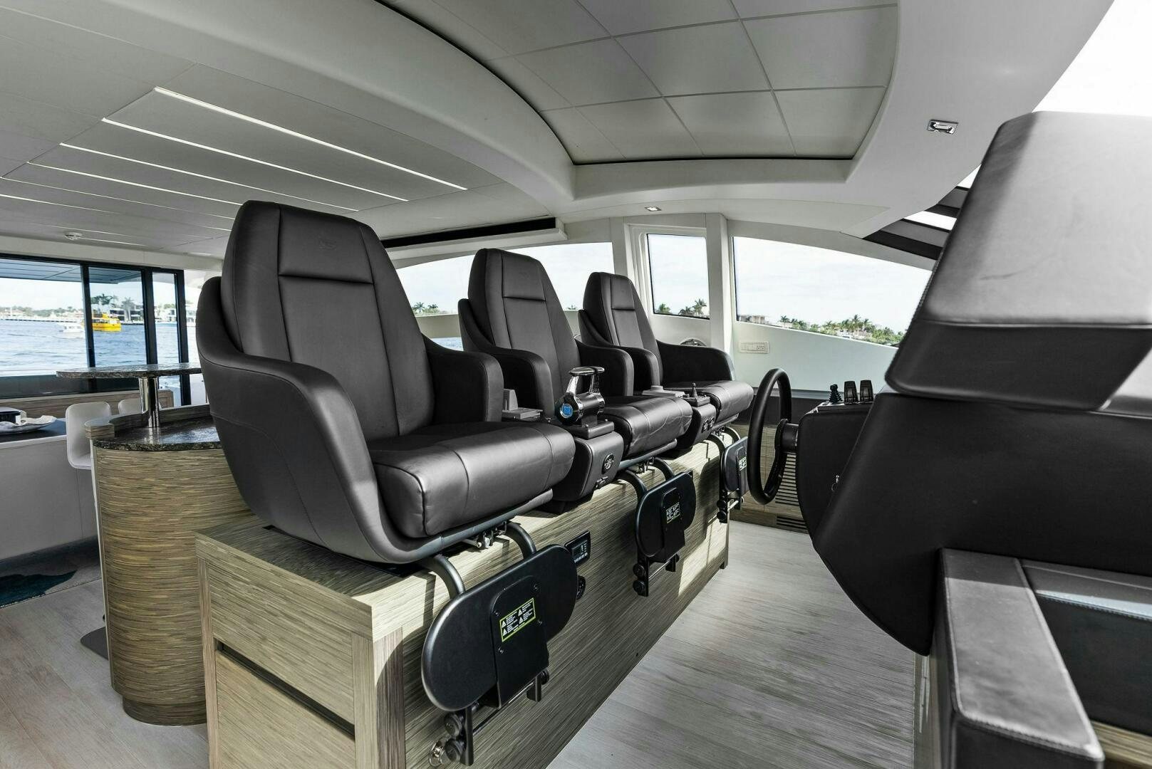 inside of a car with seats and a seat belt and a steering wheel aboard PHOENIX RISING Yacht for Sale