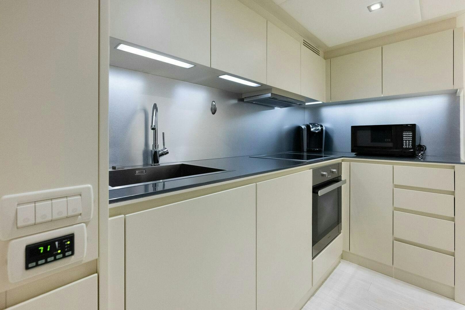 a kitchen with white cabinets aboard PHOENIX RISING Yacht for Sale