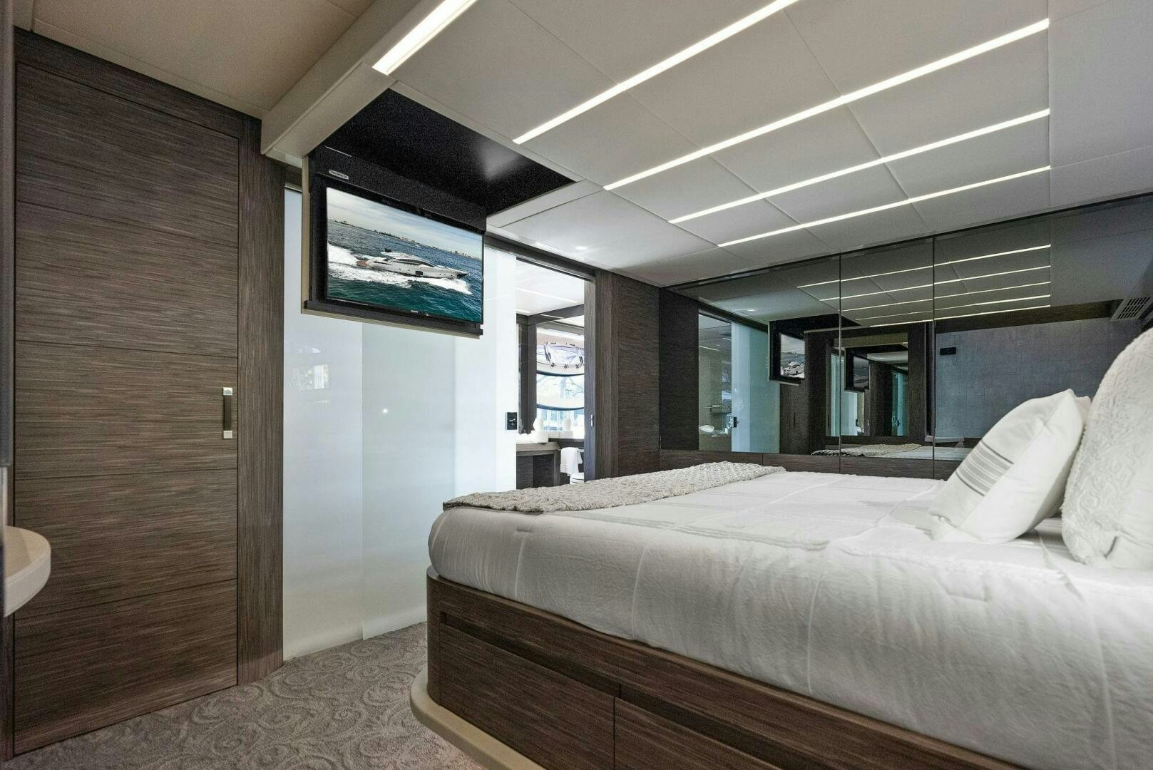 a room with a bed and a television aboard PHOENIX RISING Yacht for Sale
