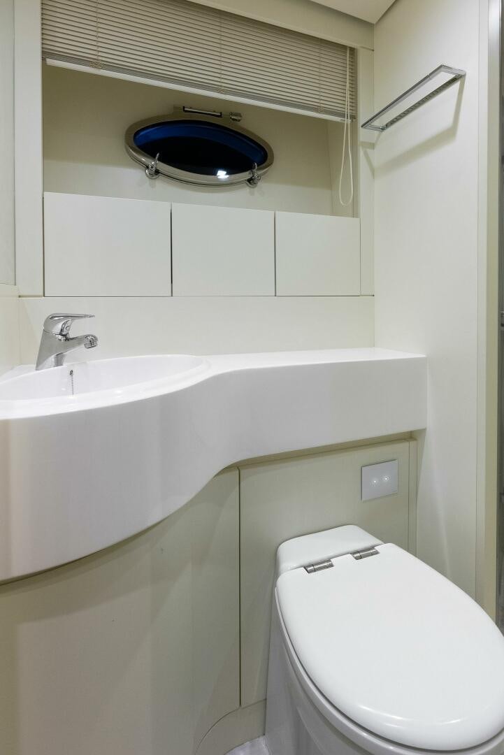 a toilet and a sink in a bathroom aboard PHOENIX RISING Yacht for Sale