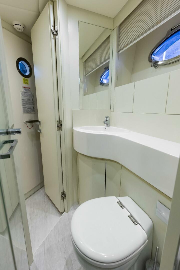 a bathroom with a toilet and bathtub aboard PHOENIX RISING Yacht for Sale