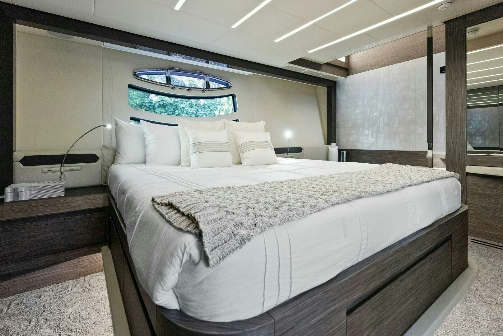 a bed with a white bed spread aboard PHOENIX RISING Yacht for Sale